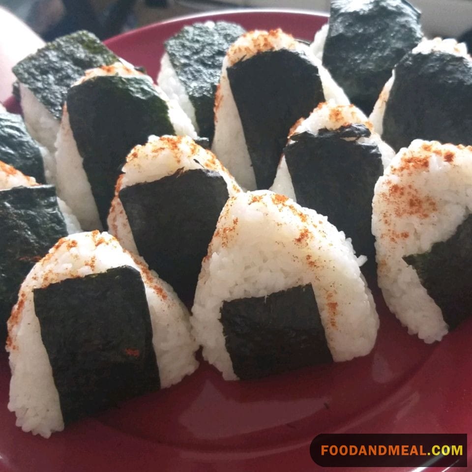 Dip, Bite, Repeat: Onigiri Taking A Soy Sauce Plunge.