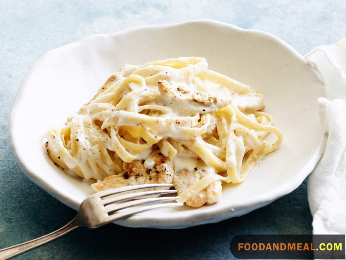 Every strand tells a story: Close-up of the creamy Fettuccine Alfredo.