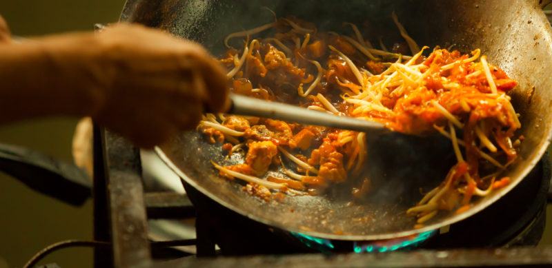 one of the most favorite and famous Asian Thai street fast food in hot pan, Pad Thai, is a stir fried rice noodle dish commonly served as a street food and at casual local eateries in Thailand.