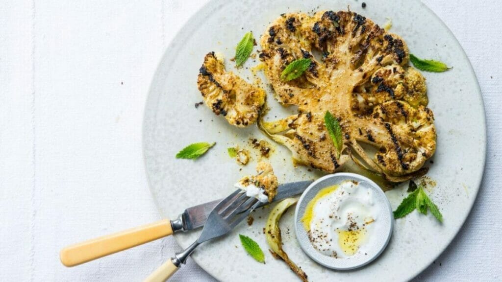 Delicately placing the cauliflower steaks onto the baking tray - spacing is key!