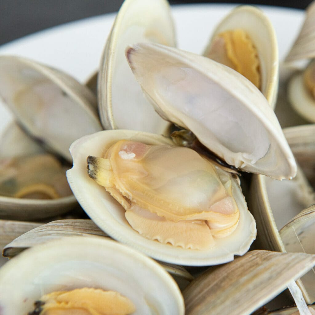 Image Of Fresh Clams Being Prepared: &Quot;Only The Finest Clams Make It To Our Recipe. Discover The Secrets Of Selecting The Perfect Seafood.&Quot;
