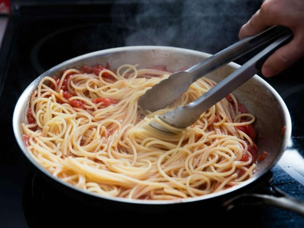 Image Of A Steaming Plate Of White Clam Sauce Spaghetti: &Quot;Dive Into A Symphony Of Flavors With Every Forkful Of Our Luscious White Clam Sauce Spaghetti.&Quot;