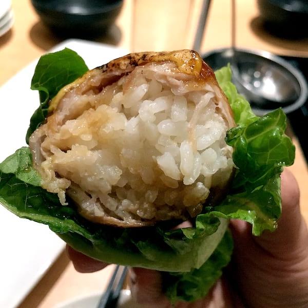 Serving Elegance: Onigiri Presented On A Bamboo Leaf.